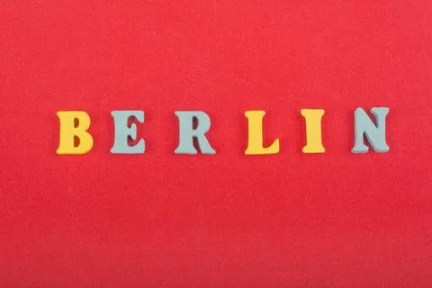 BERLIN word on red background composed from colorful abc alphabet block woode Stock Photos