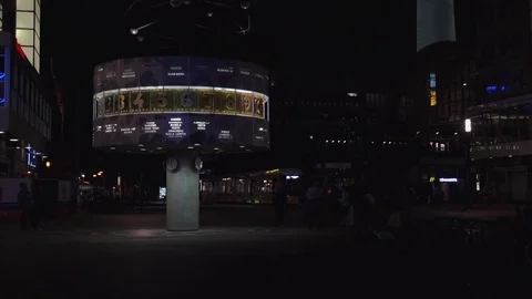 BERLIN, World clock and Alexanderplatz in night with tram and tourists. Stock Footage 78578871