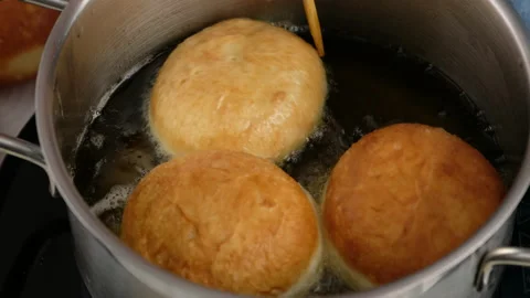 Berliners. Rolling donuts in oil. Donuts are fried in vegetable oil. Delicious Stock Footage 146866923