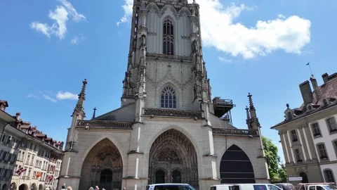 Bern Cathedral Minster tower rising above historic Old Town street in capit.. Stock Footage 343593470
