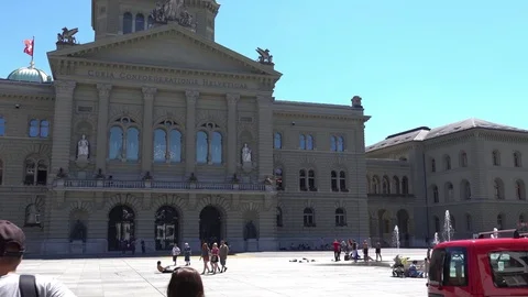 BERN, SWITZERLAND: People in fountain on the square near Federal Stock Footage