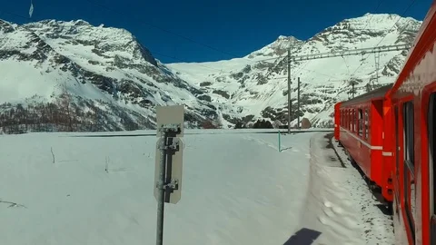 Bernina Express red train ascends to the Bernina Pass, Alp Grüm station 스톡 동영상 74063452