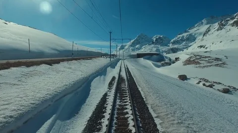 Bernina Express red train ascends to the Bernina Pass, glacier and Piz Bernina 스톡 동영상 74063456