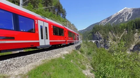 Bernina Express, red train of Bernina on the railway. Albula Pass Stock Footage 109156489