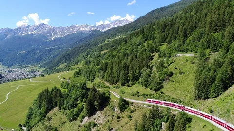Bernina Express, red train in a forest. Val Poschiavo. Stock Footage 91177922