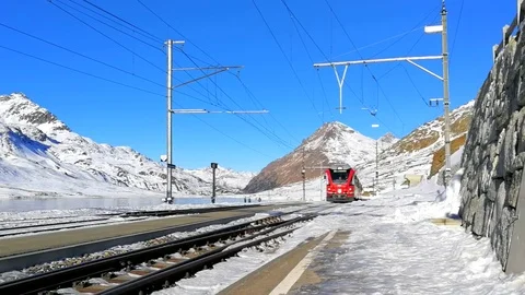Bernina Express - Red train in station on Bernina Passes by Stock Footage 71090448