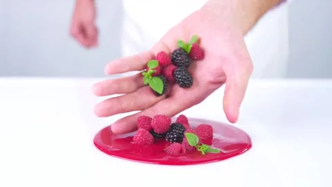 The berries are falling from the hand to the red sauce. Stock Footage 141969816