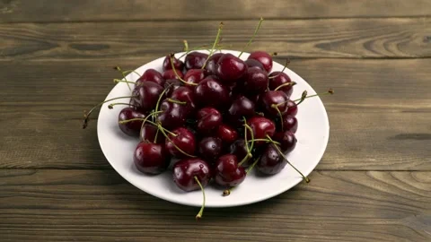 Berries the cherries in a White Plate Stock Footage 134425667