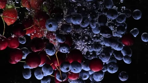 Berries fall into the water slow mo. strawberry blueberry super slow mo Video stock 159333814