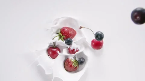 Berries falling into the milk and rotating Stock Footage 171887776
