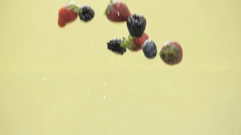 Berries fly up on yellow background 库存影片 107823175