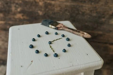 Berries folded in a circle in the shape of a clock. blue paint brush Stock Photos