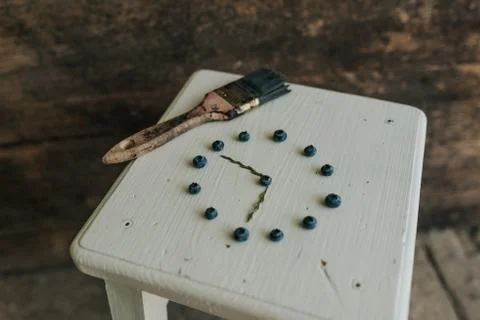 Berries folded in a circle in the shape of a clock. blue paint brush Stock Photos