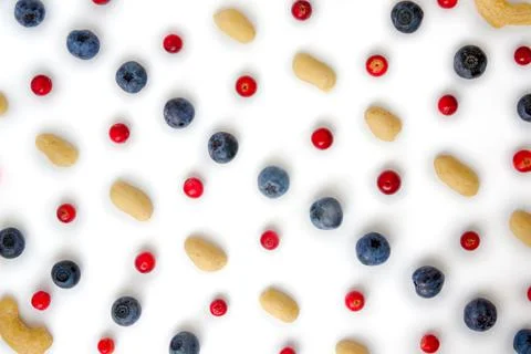Berries, nuts food pattern of Peanuts, cashews, blueberries, lingonberries Stock Photos
