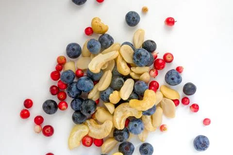 Berries, nuts food pattern of Peanuts, cashews, blueberries, lingonberries Stock Photos
