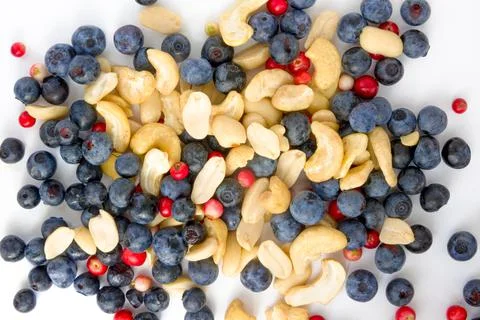 Berries, nuts food pattern of Peanuts, cashews, blueberries, lingonberries Stock Photos