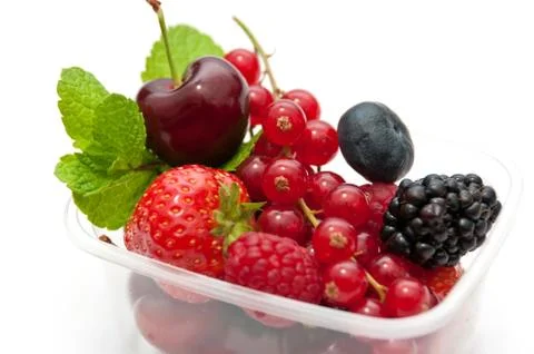 Berries in a plastic box on a white background Stock Photos