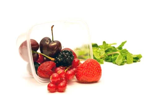 Berries in a plastic box on a white background Stock Photos