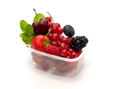 Berries in a plastic box on a white background Stock Photos
