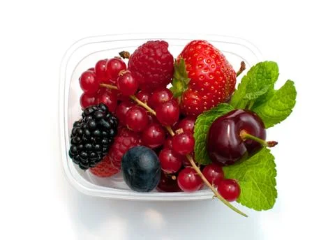Berries in a plastic box on a white background Stock Photos