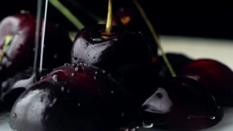 Berries of ripe large cherries with branches are watered with a stream of w.. Vidéo 306713854