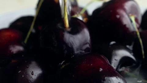 Berries of ripe large cherries with branches are watered with a stream of w.. Video stock 307439744