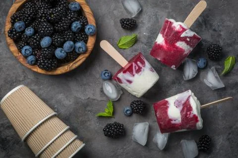 Berry popsicles on rustic background Stock Photos