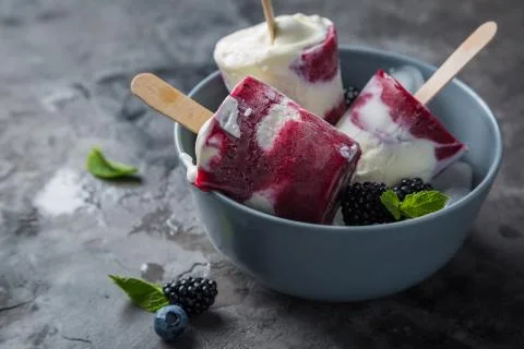 Berry popsicles on rustic background Stock Photos