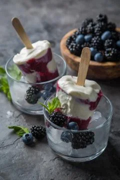 Berry popsicles on rustic background Stock Photos