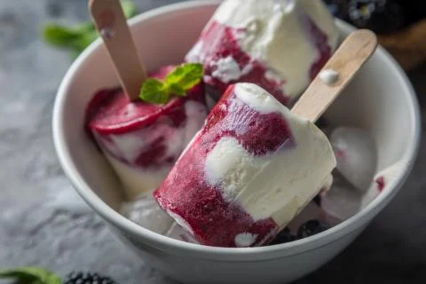 Berry popsicles on rustic background Stock Photos