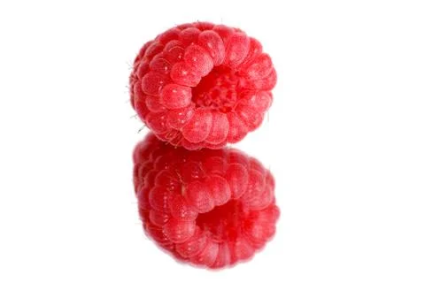 	Berry of a raspberry are reflected in a mirror Stock Photos