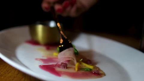 Berry red sauce raw fish carpaccio Woman holds tuna carpaccio slice on a fork Stock Footage 302279708