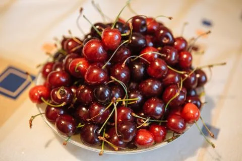 The berry of ripe cherry on the table in a plate. Stock Photos