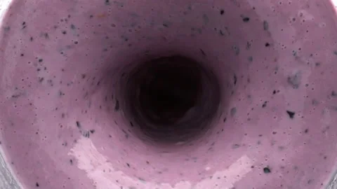 Berry smoothie blended rotating top view. Fruit milkshake liquid vortex in bowl Stock Footage 219270529