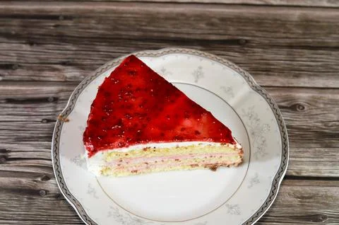Berry triangular spongy cake piece filled and topped with layers of berries.. Stock Photos
