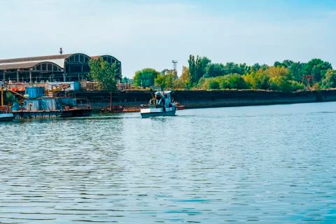 Berth at the river. A river ship is moving along the riverbed. Photos