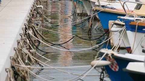 Berth. View of ropes and moored boats. Slow motion. 4k Stock Footage 128211176