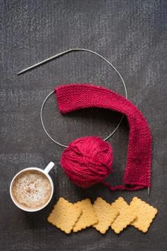 Bertical image of knitting, coffee and crackers Stock Photos
