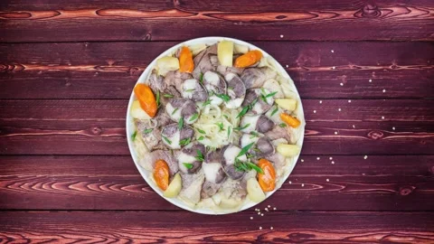 Beshbarmak dish rotates on a white plate. Noodles with lamb and onion close-up Stock Footage 128319935