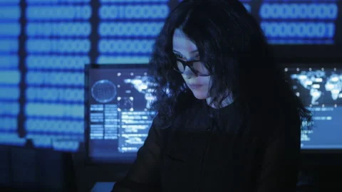 Bespectacled Woman Hacker programmer is working on computer in cyber security Stock Footage 88025195