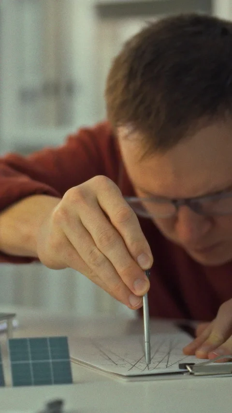 A bespectacled young engineer researches solar energy examining solar panels Stock Footage 334395828