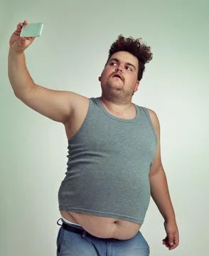 This is the best angle. an overweight man taking a selfie from a high-angle. Stock Photos