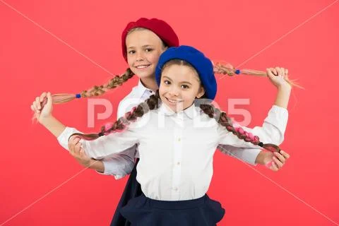 Best braided hairdo. Small girls being proud of long braid hairdo on pink Stock Photos
