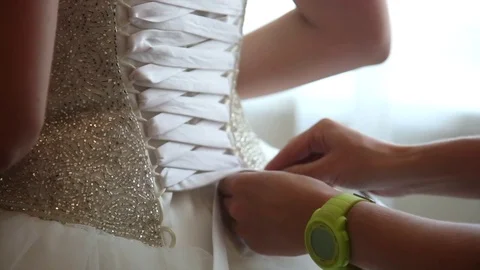 Best friend helps future bride to wear a wedding dress. closeup. Stock Footage 71023930