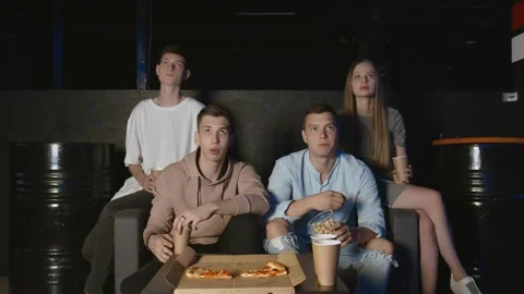 Best friends eating popcorn and pizza watching movie or tv show at home. People Stock Footage 136337451