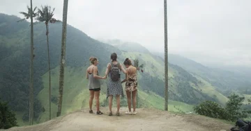 Best friends enjoying view and taking pictures of tropical wax palm valley Stock Footage 86151908