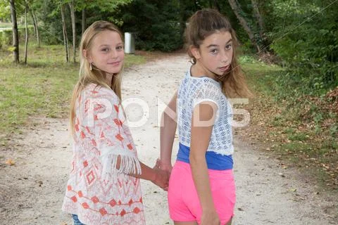 Best Friends Forever - two teenage girls holding hands Stock Photos