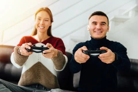 Best friends having fun while playing computer games at home Stock Photos