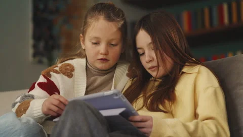 Best friends play educational game on tablet at home, interactive learning Stock Footage 343424147
