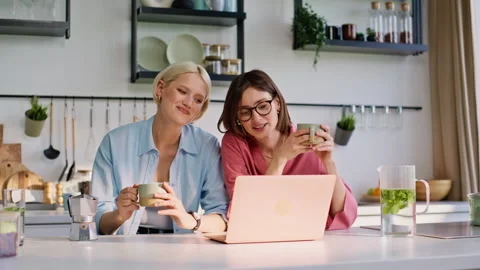 Best friends talking virtual call looking computer screen at kitchen closeup Video stock 335104208